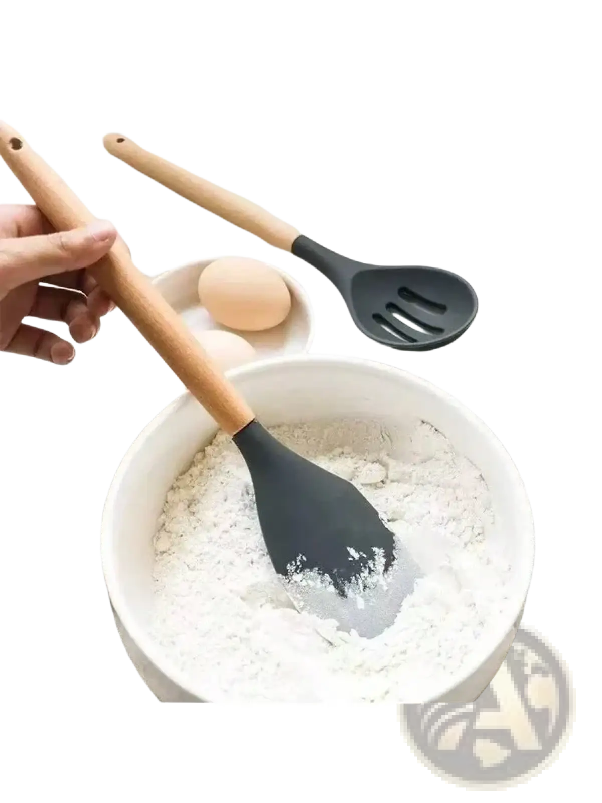 Black silicone spatula with wooden handle resting in a white bowl of flour from silicone kitchen utensil set
