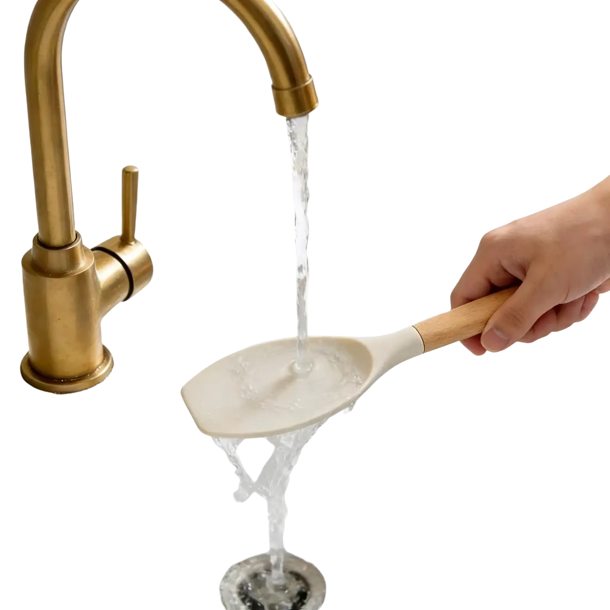A beige silicone spatula with wooden handle from silicone kitchen utensils set 14 piece rinsed under running water
