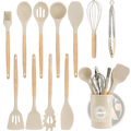 Beige silicone kitchen utensils set 14 piece with wooden handles neatly organized in a matching ceramic storage cup