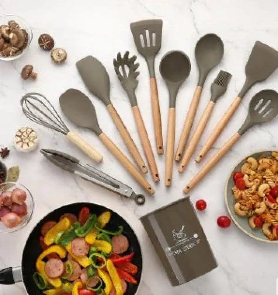 Set of gray silicone and wood heat resistant cooking utensils arranged in a kitchen scene for cooking use