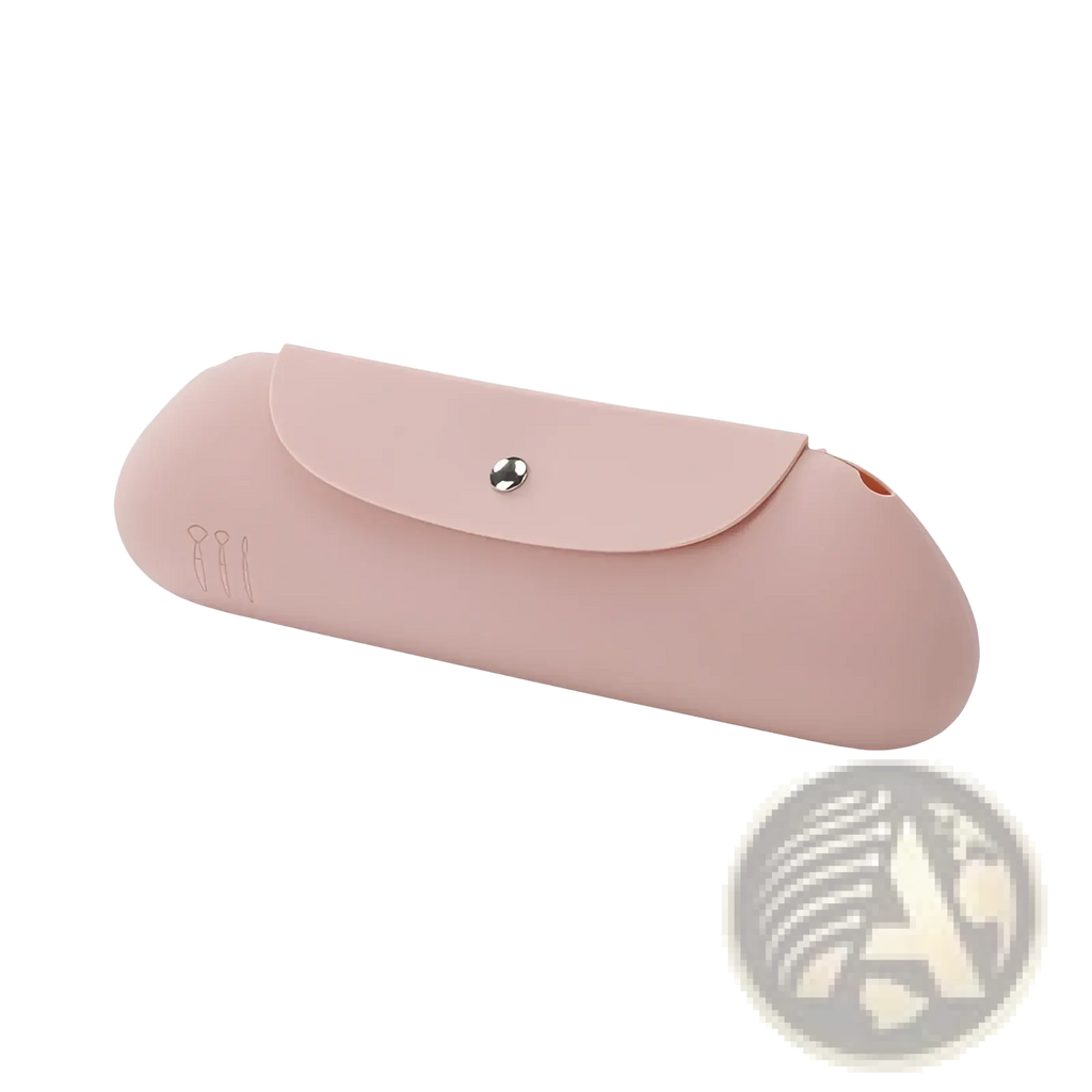 Pink silicone makeup brush travel bag with silver snap button closure and subtle engraved logo on the side