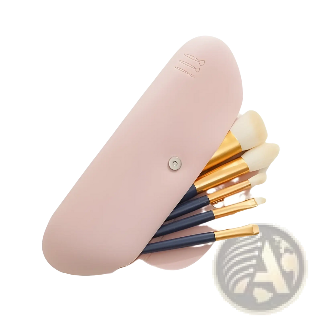 Pink silicone makeup brush travel bag case with gold and navy handles holding soft-bristled brushes