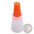 Orange silicone oil dispenser brush with translucent white plastic handle for cooking and baking use