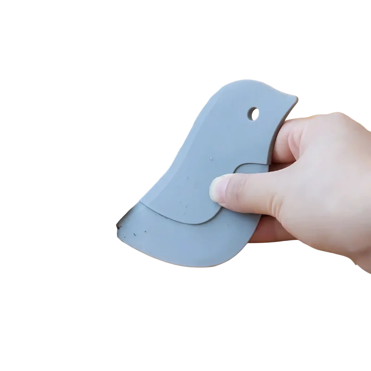 Gray silicone bird-shaped kitchen scraper silicone pan scraper and grease cleaning tool removing debris from countertop edge