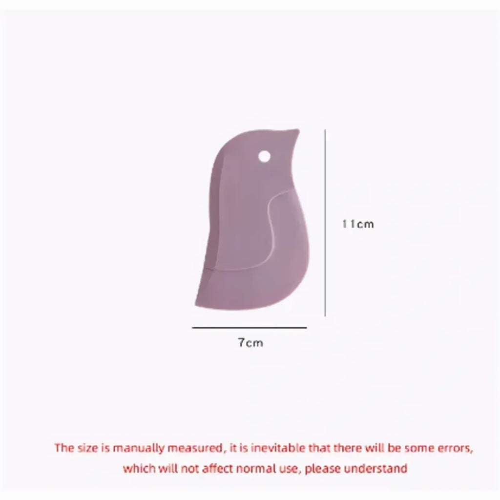 A soft lavender silicone bird-shaped pan scraper and grease cleaning tool measuring 7cm by 11cm