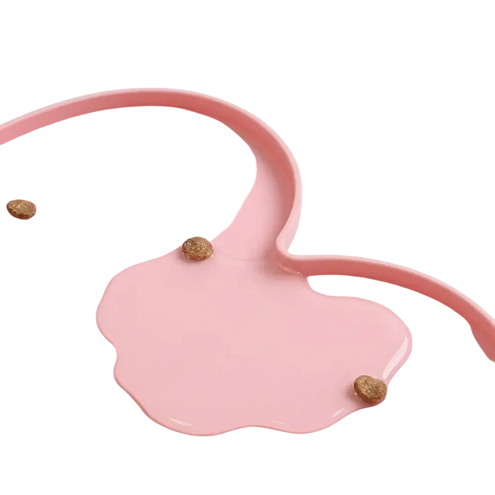 Pink heart-shaped silicone pet feeding mat with a glossy finish and raised edges to prevent overflow