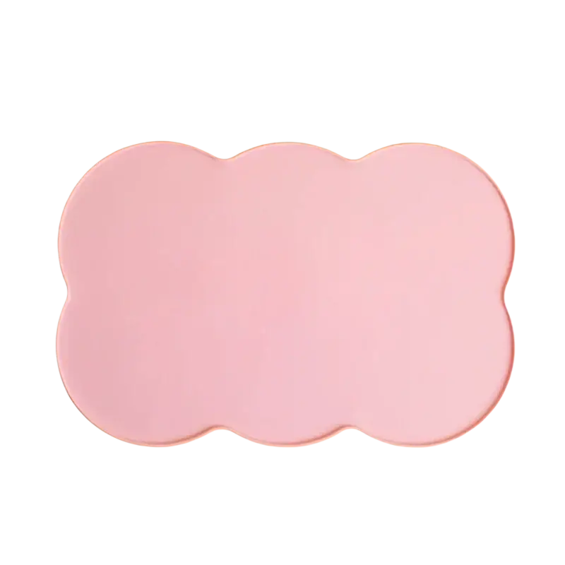 A soft pink cloud-shaped silicone pet feeding mat with a smooth matte finish and non-slip surface