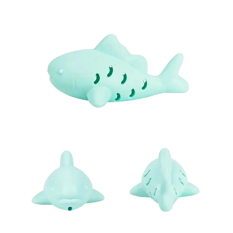 Mint green silicone shark-shaped treat dispensing fish toy with perforated body and rounded fins for small pets