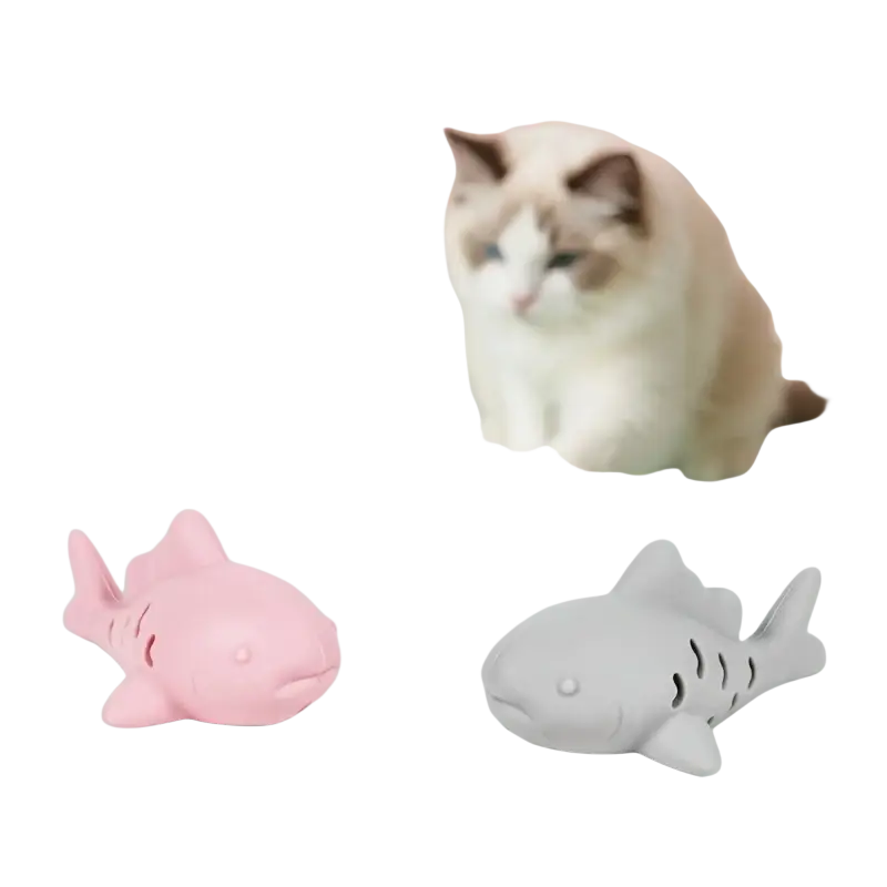 Silicone treat dispensing fish toy for small pets in pink and gray with textured surfaces for interactive play