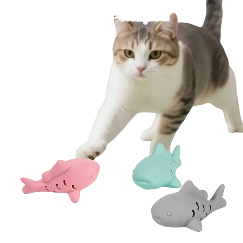 Silicone treat dispensing fish toy for small pets in pink light blue and gray with perforated soft silicone design