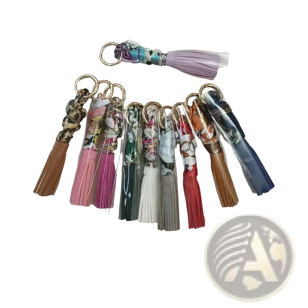 Silk scarf tassel keychains for bags in various colorful patterns and hues with fringe detailing