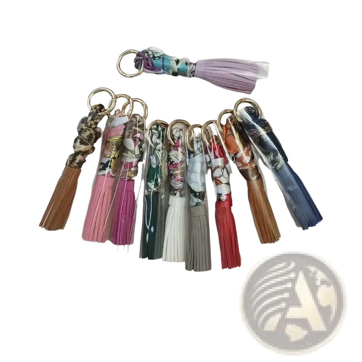 Silk scarf tassel keychains for bags in various colorful patterns and hues with fringe detailing