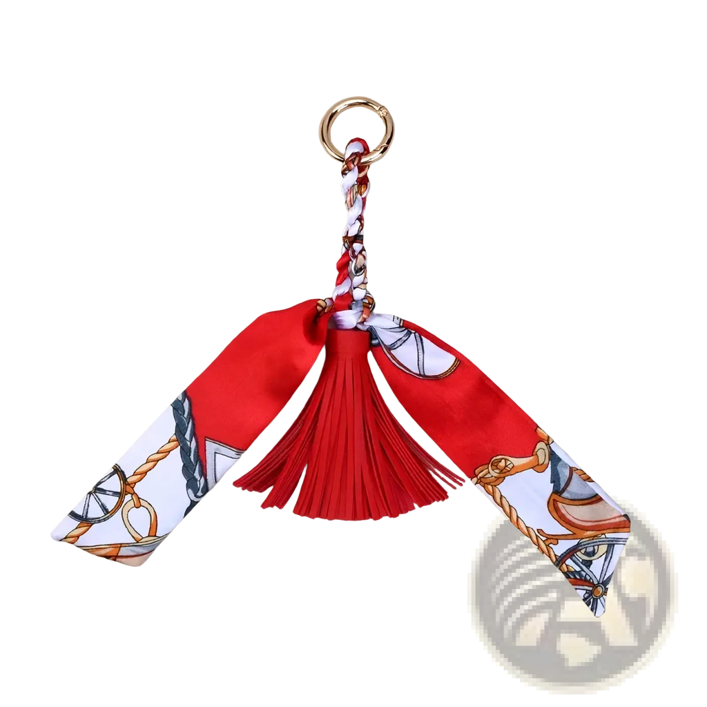 Silk scarf tassel keychain for bags featuring red silk material with horse harness print and matching red tassel accessory