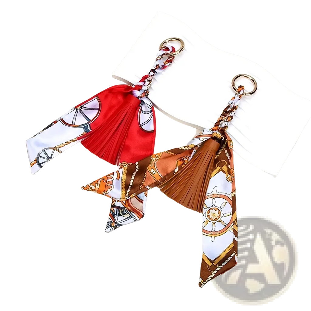 Two nautical-themed silk scarf tassel keychains in red and brown white with ship wheel and rope patterns for bags