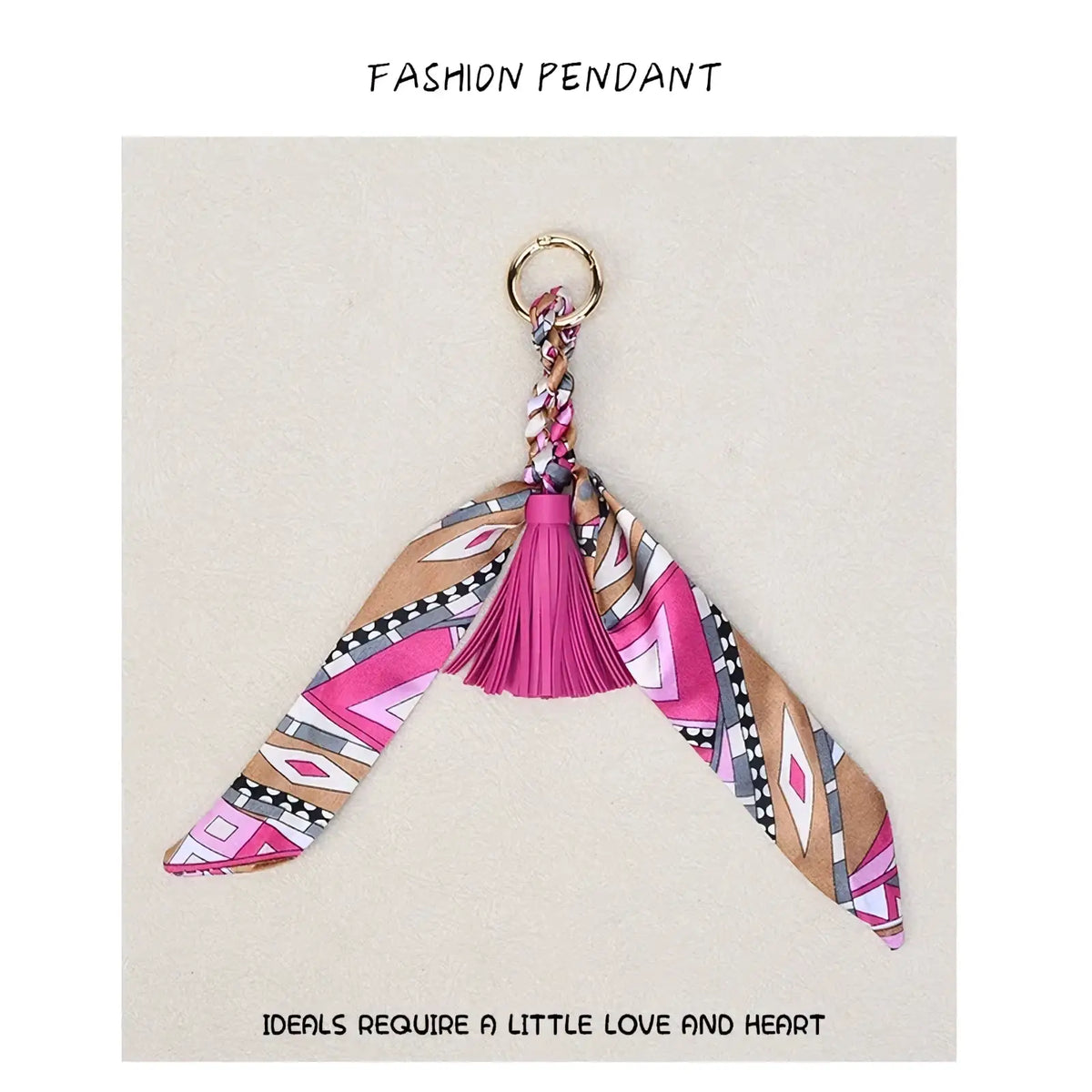 Silk scarf tassel keychain for bags with a vibrant pink and beige patterned silk scarf and matching tassel detail