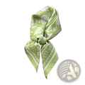 A light green silk square scarf with white floral and geometric patterns tied as an elegant retro neckerchief