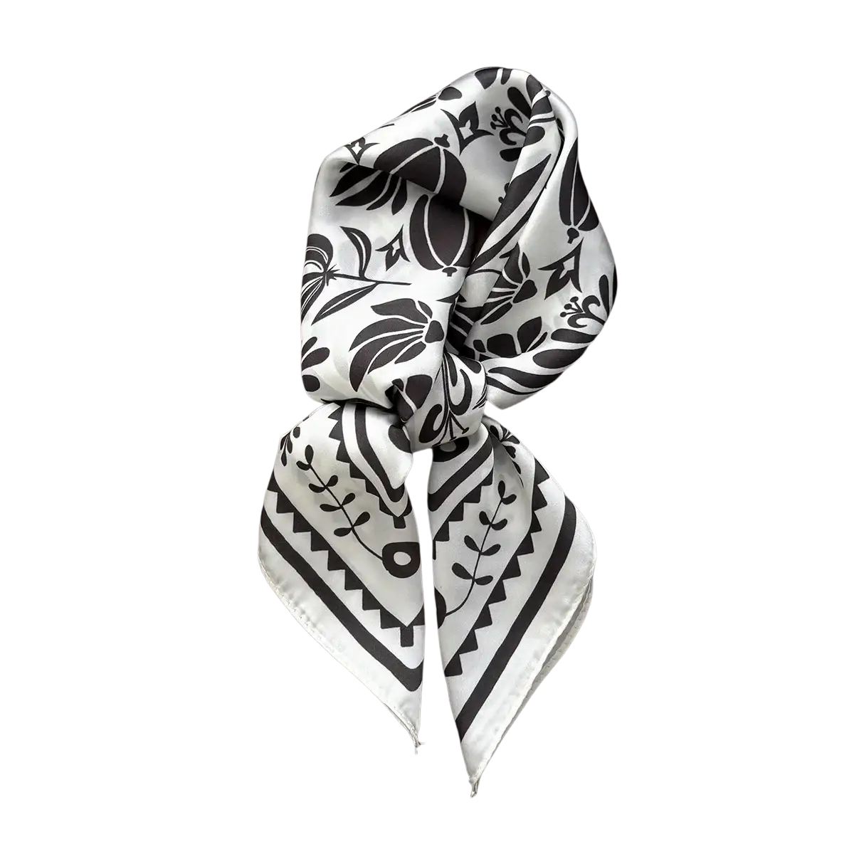A delicate white silk square scarf with bold black botanical and geometric patterns folded in a rectangular box