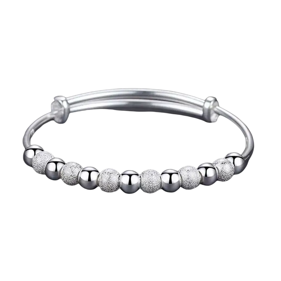 Silver beaded bangle bracelet for women featuring alternating polished and textured silver spherical beads, adjustable design