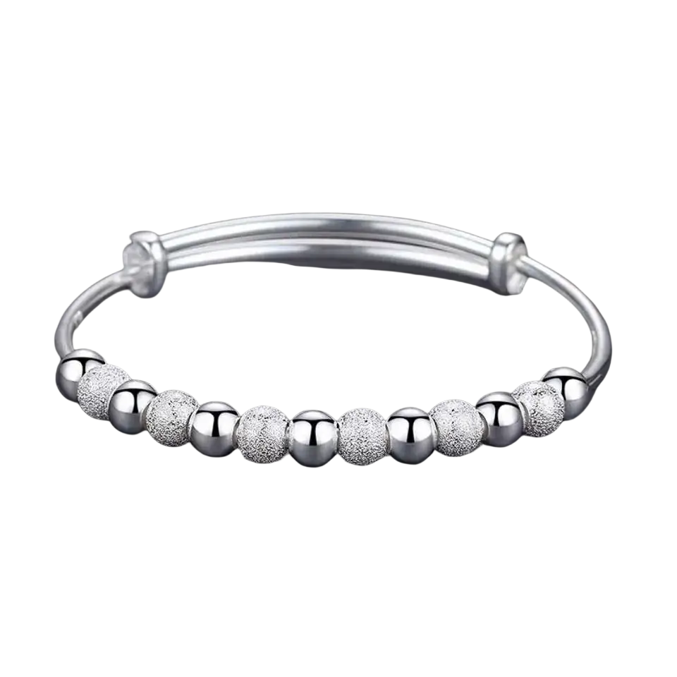 Silver beaded bangle bracelet for women with alternating smooth and textured spherical silver beads, adjustable design