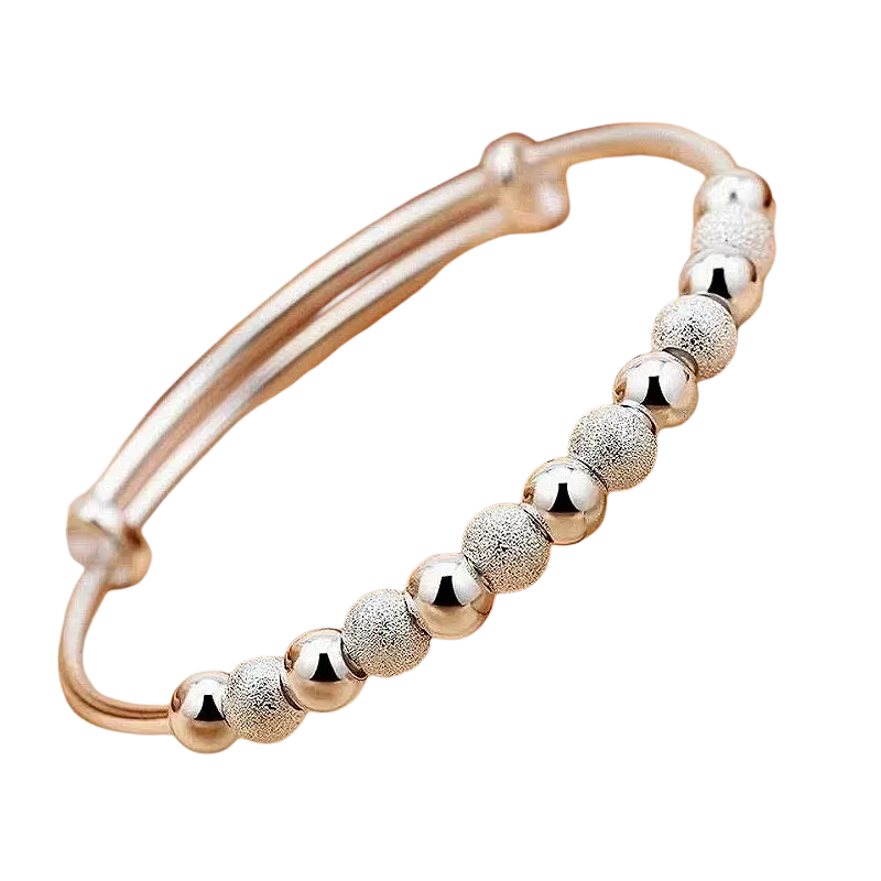 Silver beaded bangle bracelet for women featuring alternating polished and textured spherical silver beads adjustable fit