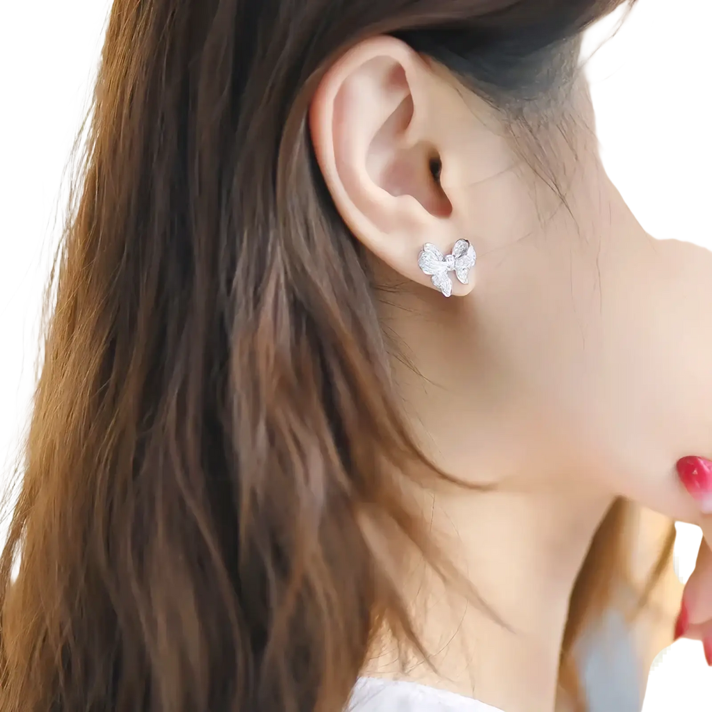 Silver butterfly-shaped stud earring with sparkling crystals from silver bowknot zircon necklace and earrings set
