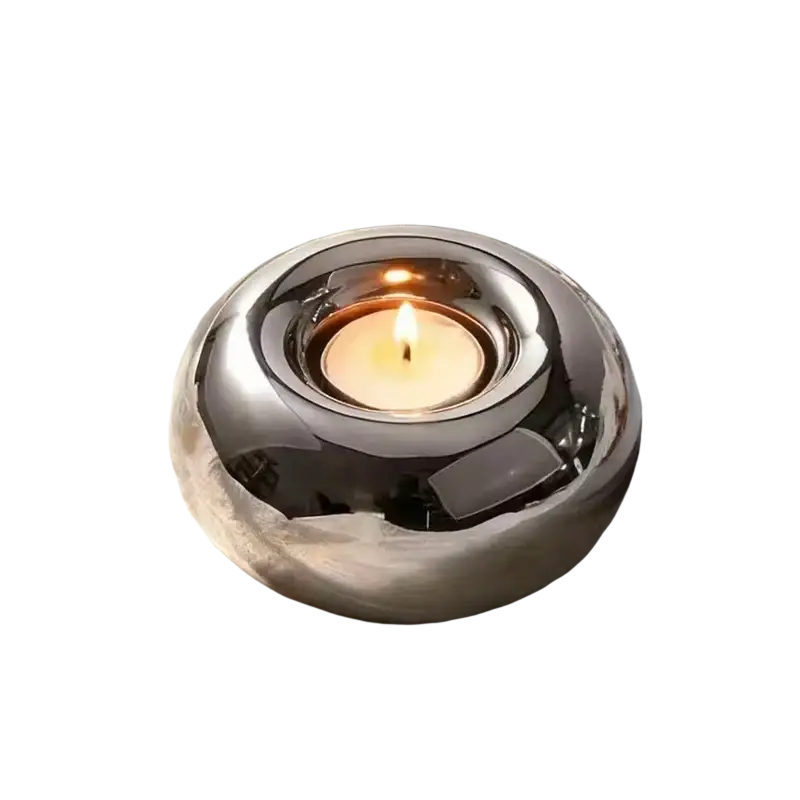 Shiny silver ceramic sphere candle holder with smooth rounded design for elegant home decor