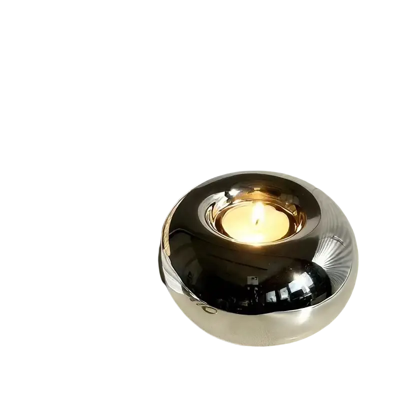 Silver ceramic sphere candle holder with a shiny metallic smooth reflective surface for decorative use