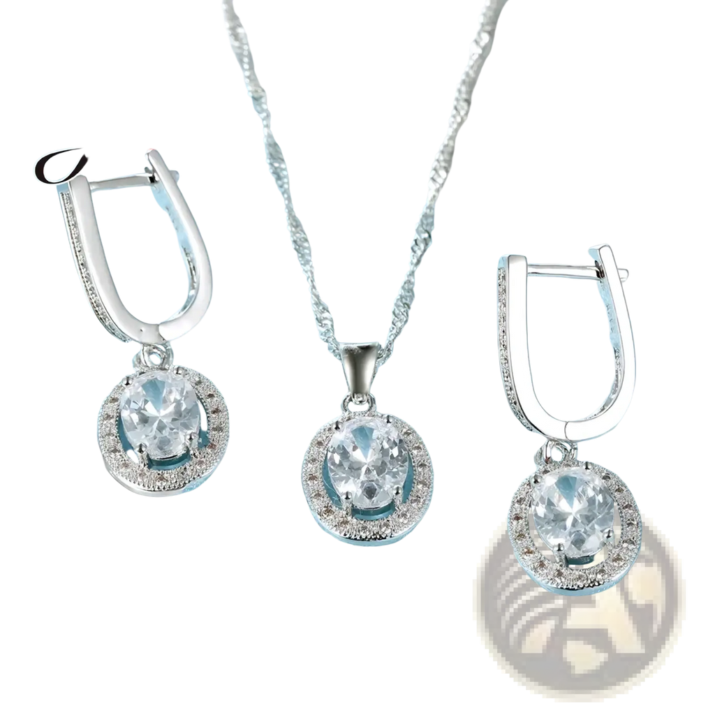 Silver crystal jewelry set necklace and earrings with oval-cut clear stones and halo crystals on light blue fabric