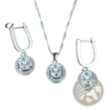 Silver crystal jewelry set necklace and earrings with oval-cut clear stones and halo crystals on light blue fabric
