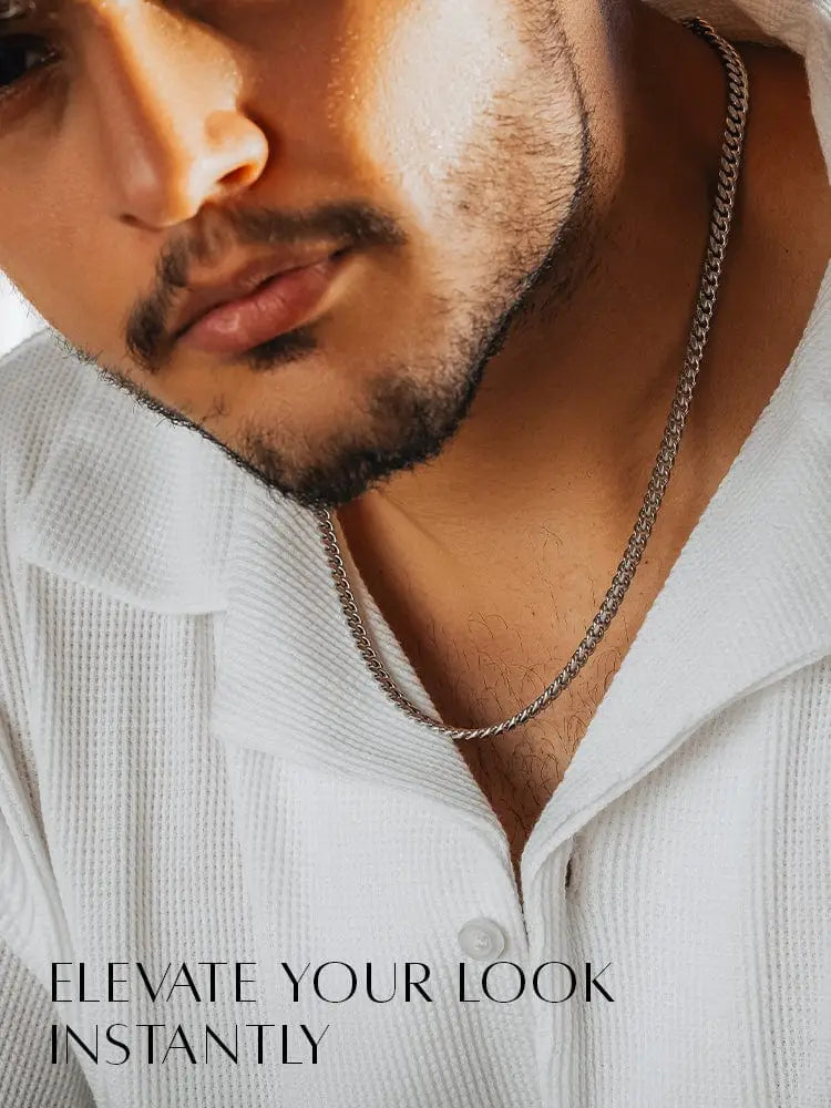 5mm silver diamond cut Cuban link chain necklace in silver tone with textured interlocking links worn on the collarbone