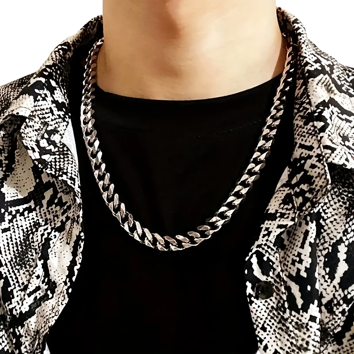 Silver-toned thick Cuban link chain necklace for men worn around the neck showcasing its bold design