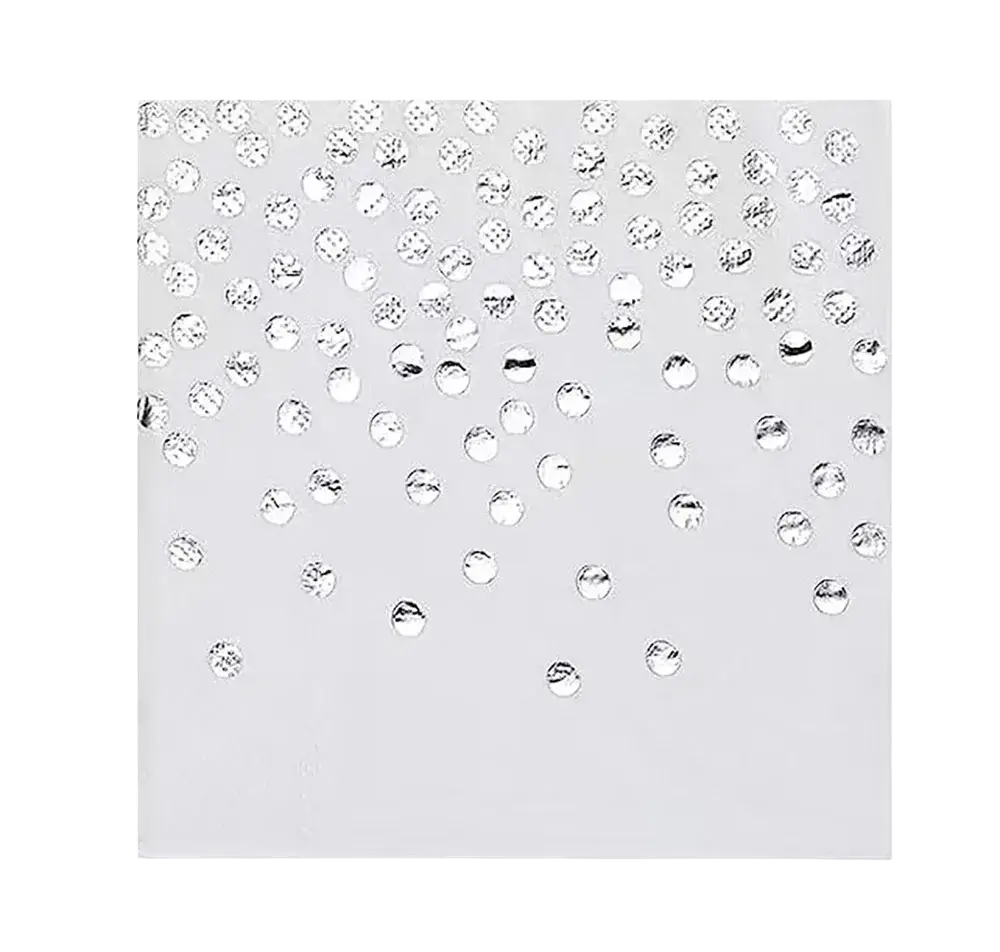 Silver disposable party tableware set featuring silver rhinestone confetti scattered on a white background