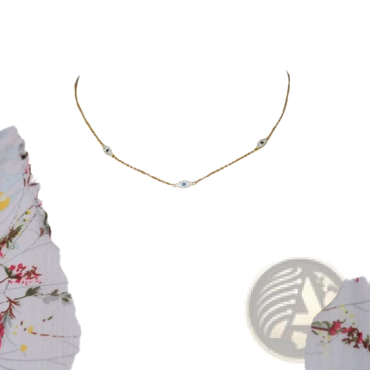 A delicate silver evil eye charm necklace with three gold eye-shaped pendants featuring blue cz crystals
