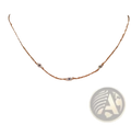 A delicate silver chain necklace with three small sparkling cz crystal evil eye charms in gold accents