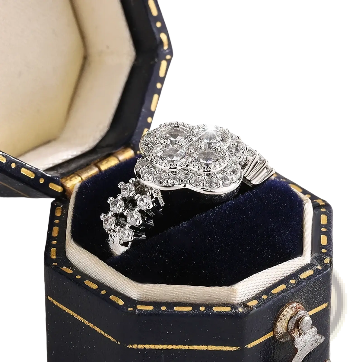 A silver four leaf clover diamond ring with a sparkling cluster of clear stones in an ornate multi-tiered design