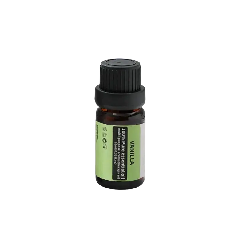 A small amber glass bottle of 100% pure vanilla essential oil with black cap on a silver metallic aromatherapy bowl