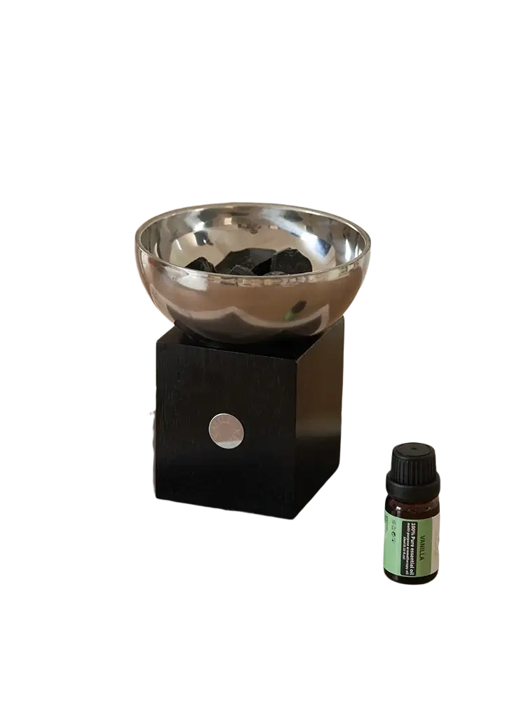 Shiny silver metallic aromatherapy bowl with sleek modern design on black square base with circular cutout