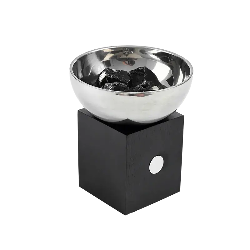 Shiny silver metallic aromatherapy bowl with a black wooden base and circular white accent