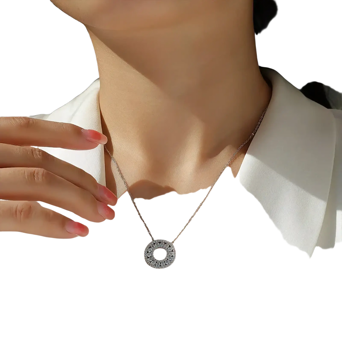 A delicate silver moissanite halo pendant necklace featuring a circular pendant with sparkling stones around its edge