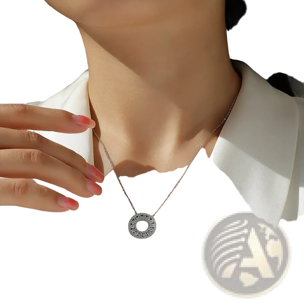 A delicate silver moissanite halo pendant necklace featuring a circular pendant with sparkling stones around its edge