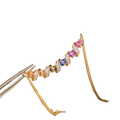 Delicate silver necklace with a spiral gold pendant adorned with colorful gemstones and sparkling diamonds
