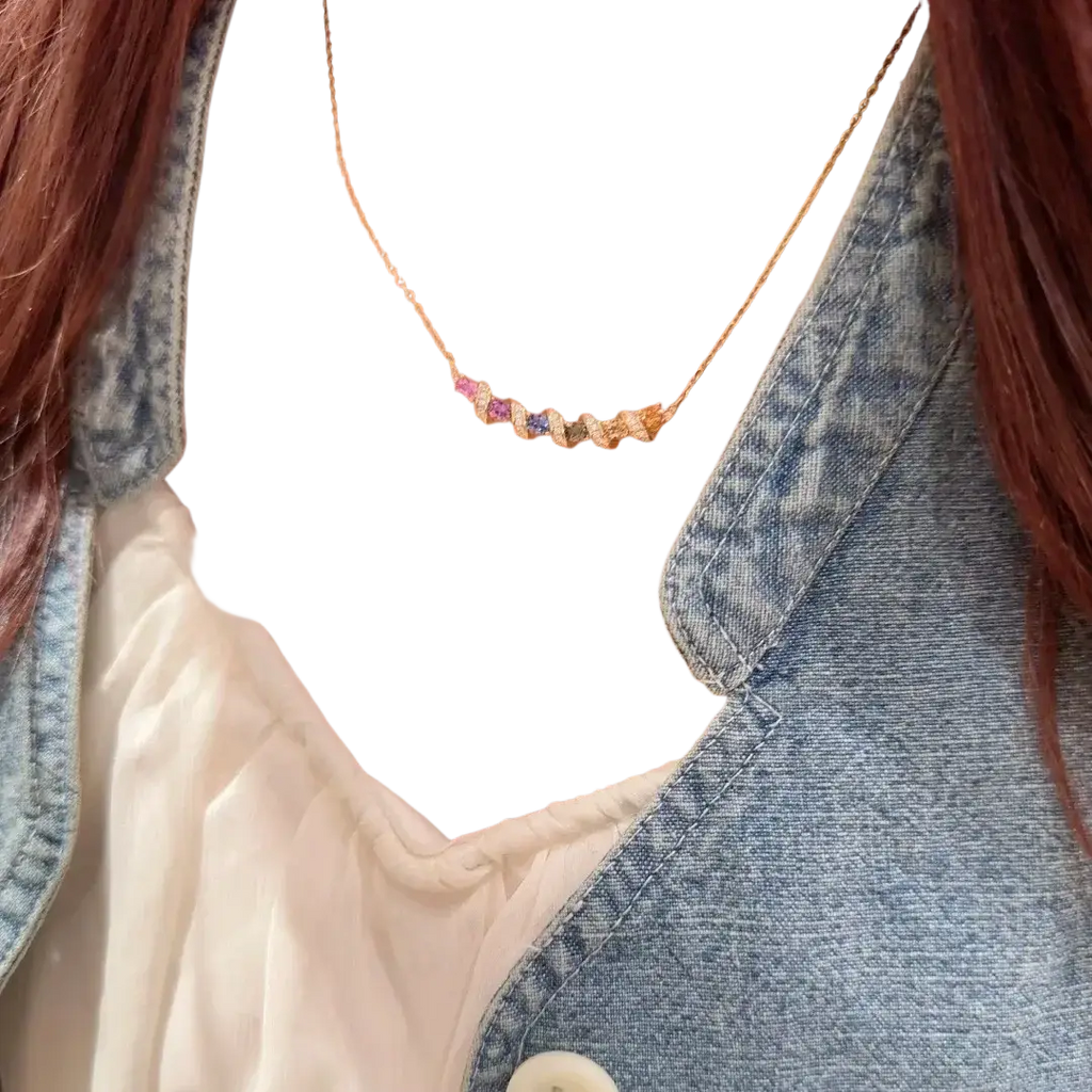 Silver necklace featuring a delicate gold chain with a horizontal bar adorned with multicolored faceted gemstones