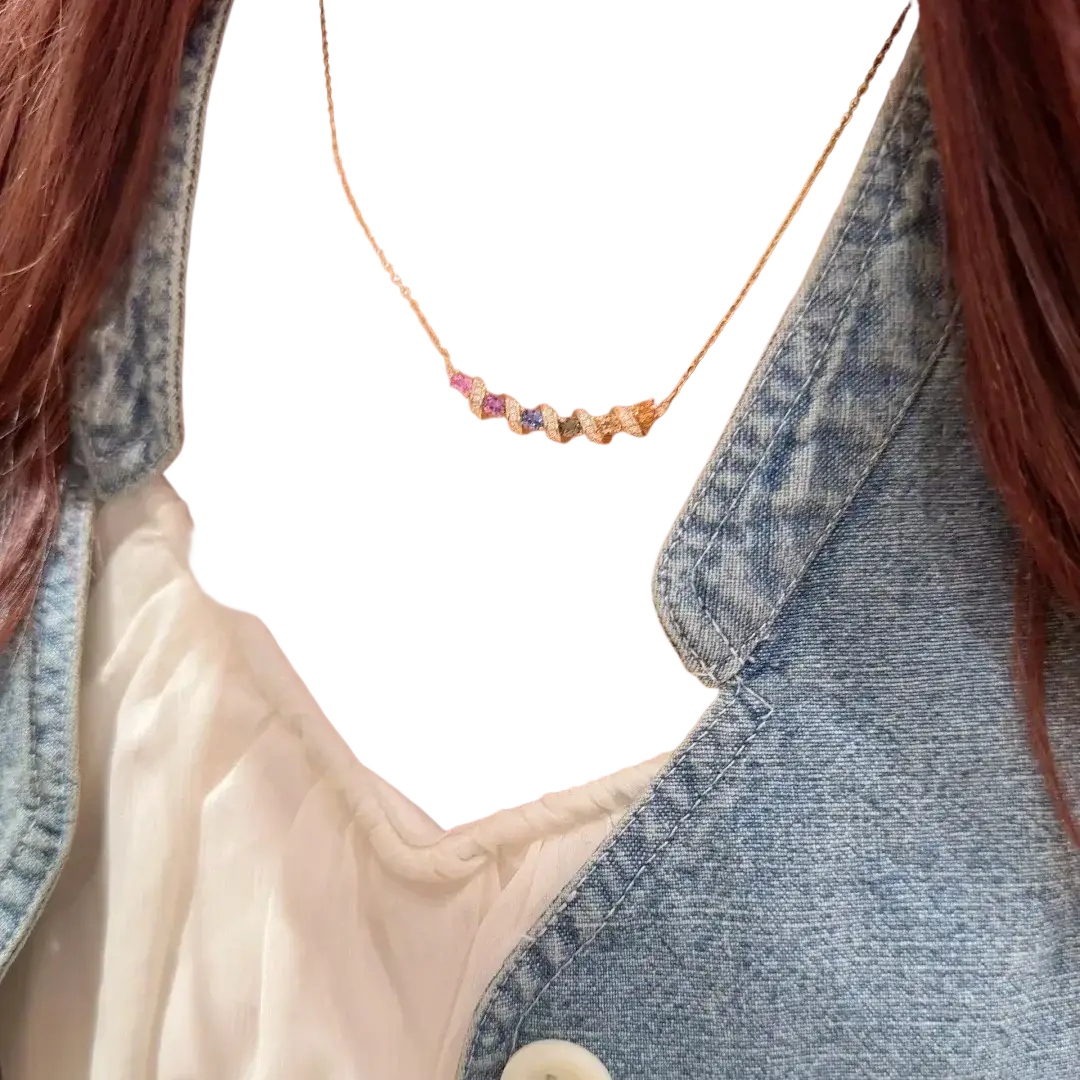 Silver necklace featuring a delicate gold chain with a horizontal bar adorned with multicolored faceted gemstones