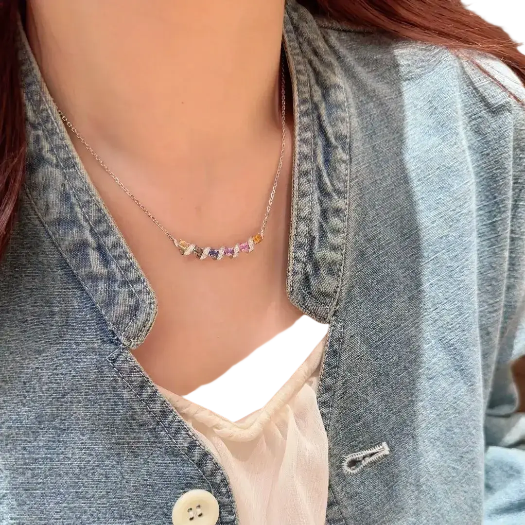 Silver necklace featuring a delicate gold chain with colorful rectangular-cut yellow purple and pink gemstones
