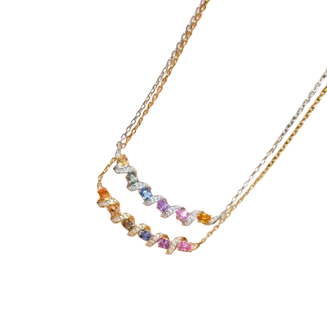 Delicate silver necklace with two tiers featuring a spiral geometric pendant and colorful gemstones in gold and silver tones