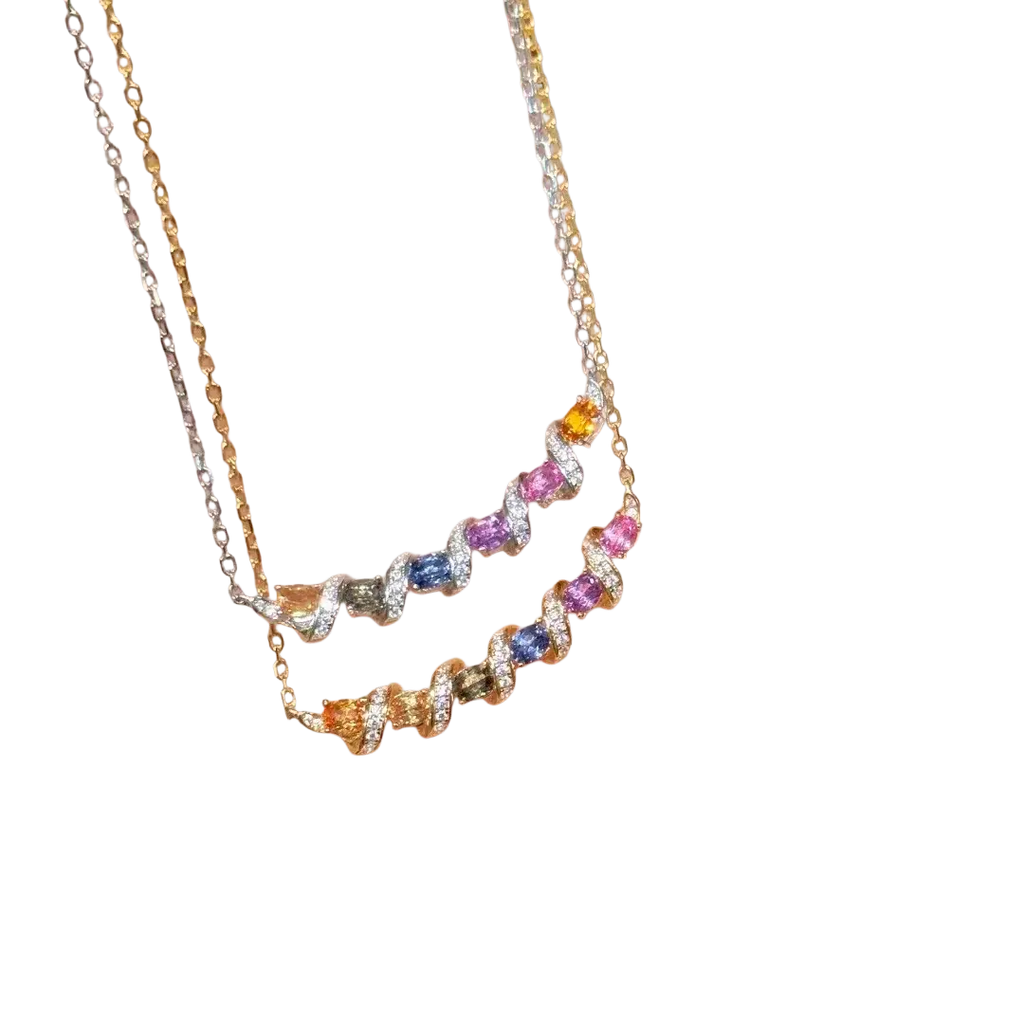 Two silver necklaces with gemstone-encrusted twisted bar pendants and silver-toned chains in a geometric design