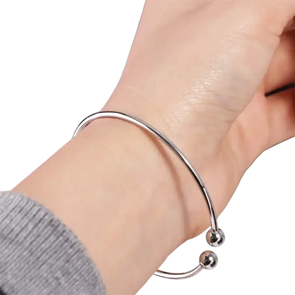 Silver plated adjustable open bangle bracelet featuring two small silver spherical beads at the ends