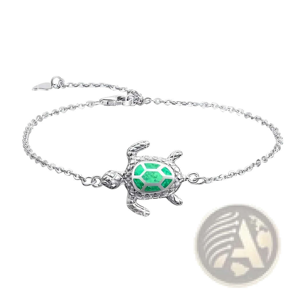 Silver sea turtle opal inlay anklet featuring a silver turtle charm with a green gemstone encrusted shell and delicate chain