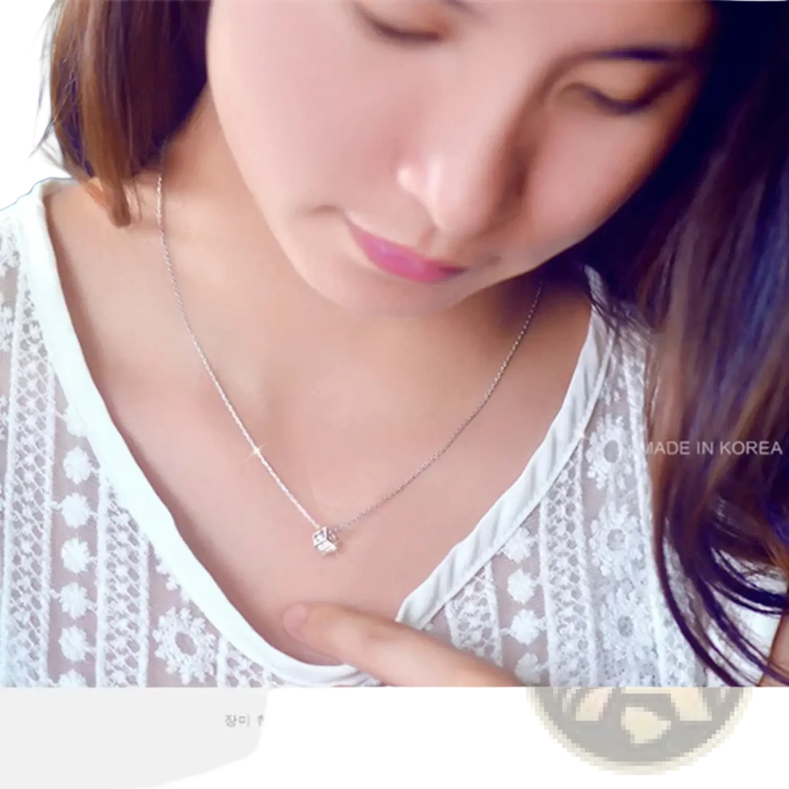Silver square zircon pendant necklace with a delicate silver chain and a small intricate butterfly pendant