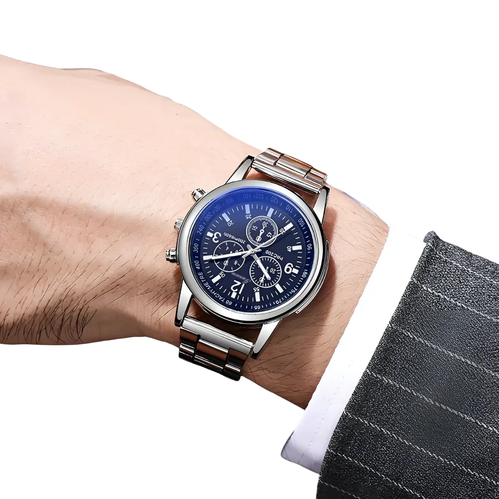 Silver stainless steel quartz chronograph watch with deep blue dial and white markings worn on a mans wrist